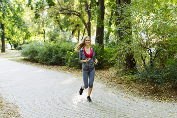 Young blonde woman jogging