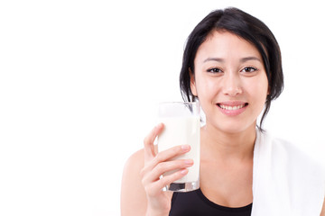 smiling, sporty, healthy woman with a glass of milk