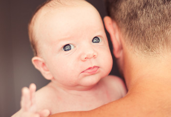 Father holding newborn baby.