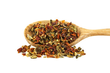 Mixture of dry peppers in wooden spoon on a white background