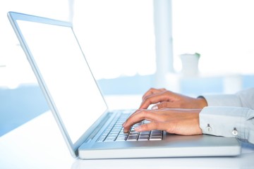 Cropped image of woman using laptop