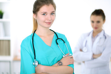 Fototapeta premium Portrait of young female surgeon doctor in a hospital