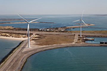 Windmills for renewable electric energy production on an island in the sea