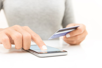 closeup woman hand using phone and credit card shopping online