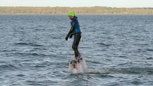 Man flying over the water on flyboard