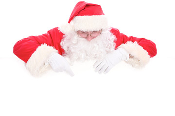 Kind Santa Claus looking out from behind the blank sign isolated on white background with copy space