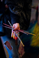 The image of artist's hand coloured by the paints