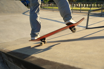 skateboarder riding on skateboard at  skatepark ramp