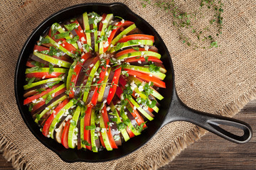 Traditional raw vegetable ratatouille in cast iron frying pan preparation recipe heathy organic...