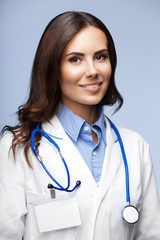 smiling female doctor, on grey