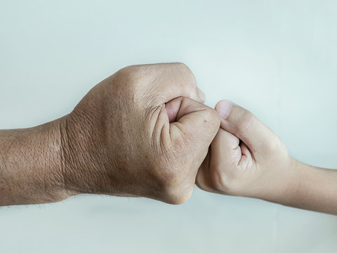 Fight, Close Up Of Two Fists Hitting Of A Man And A Boy.