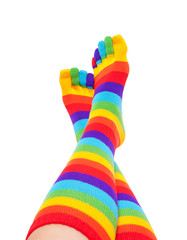 feet and legs in striped rainbow socks