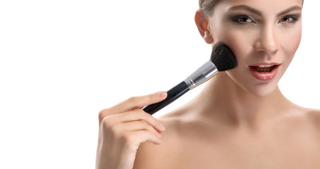 Fototapeta premium Beauty portrait of a woman on a white background with a brush