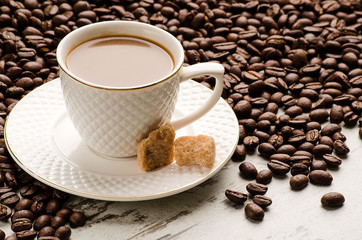 White coffee Cup and coffee beans on the table
