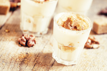 Fresh homemade dessert of bananas, yogurt and nuts, selective fo