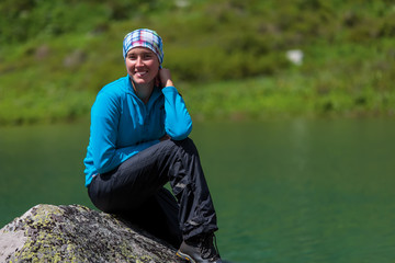 Backpacker is resting while hiking in mountains