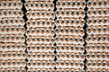 stack of fresh eggs in paper containers carton