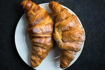 Two Fresh Croissants with Icing are ready for the Breakfast