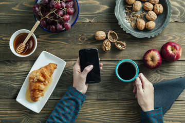 top view of a breakfast table and hands of a woman