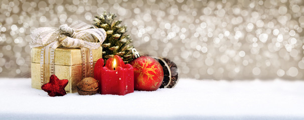 Fototapeta na wymiar Christmas gift box with decoration isolated on golden background.