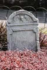 Tombstone and graves in an ancient church graveyard