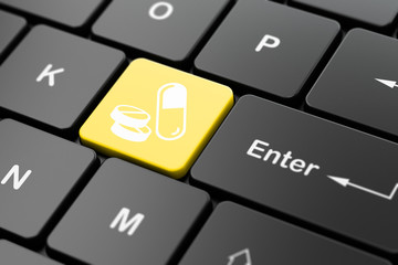 Medicine concept: Pills on computer keyboard background