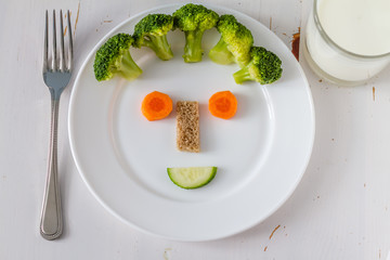 Fruits and vegetables arranged to look appealing to kids in funny face