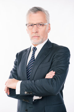 handsome confident  businessman with gray beard and glasses cros