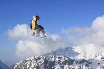 flying snowboarder on mountains