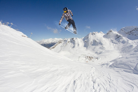 flying snowboarder on mountains