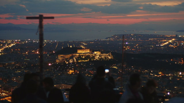 Tourists at Lycabettus hill enjoying night view of Acropolis,Athens