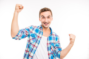 Confident cheerful handsome man lifting hands up