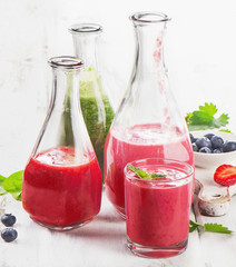 Healthy fresh smoothies on  white wooden table.