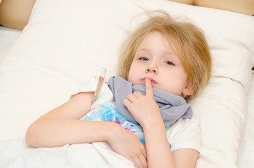 Sick little girl lying in the bed with temperature