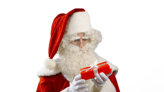 Santa Claus is curious - he is examining a gift