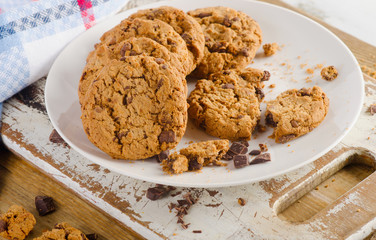 Chocolate chip cookies on a wooden board.