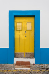 Antique vintage door usual Portuguese home. Blue and yellow.