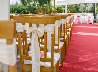 Red carpet and decorations at a wedding ceremony. Chair closeup.
