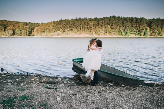 The bride and groom after the wedding, in a boat on the lake