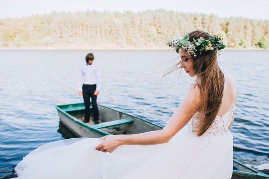 The bride and groom after the wedding, in a boat on the lake