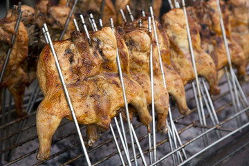 Grilled chicken thigh on the flaming grill