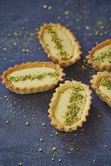 tartalets with cream and pistachio nuts