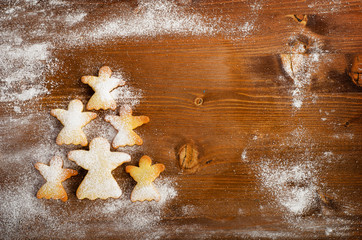 Christmas tree of homemade angel cookies on wooden table.