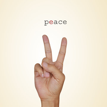man hand giving the V sign and the word peace
