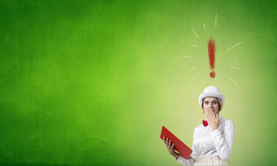 Astonished woman looking in book