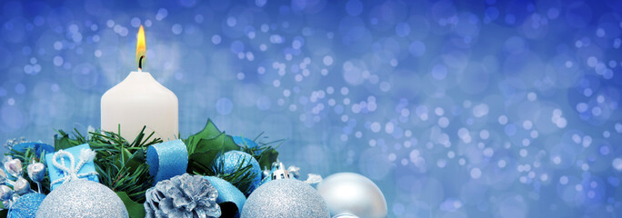 White Advent candle and Christmas decoration.