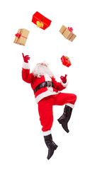Santa Claus juggles with Christmas gifts isolated on white background