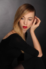 portrait of blond young woman with make up and red lips.