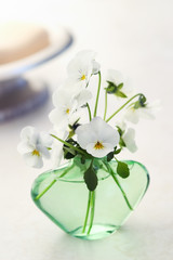 Bath scene with soap and white pansies