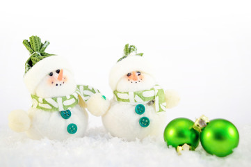 Green christmas decoration with snowman and snow